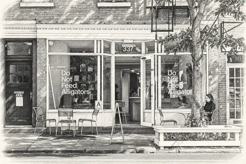 Graphite sketch of Do Not Feed Alligators at 337 Bleecker Street, with stacked window lettering, open door, sidewalk chairs and a tree.